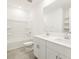 Clean bathroom featuring a dual sink vanity, a bathtub with a shower, and neutral tile floors at 4032 S 176Th Dr, Goodyear, AZ 85338