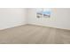 Bright bedroom featuring neutral carpet, a window and blank white walls ready for decor at 4032 S 176Th Dr, Goodyear, AZ 85338