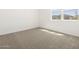 Cozy bedroom with plush carpeting, and a window offering natural light to the room at 4032 S 176Th Dr, Goodyear, AZ 85338