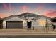 Inviting exterior view of home with garage, showcasing its modern design and attractive landscaping at 4032 S 176Th Dr, Goodyear, AZ 85338