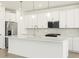 Modern kitchen featuring white cabinets, stainless steel appliances, and a large center island with pendant lighting at 4032 S 176Th Dr, Goodyear, AZ 85338