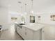 Open concept kitchen with island and sink overlooking the living and dining area at 4032 S 176Th Dr, Goodyear, AZ 85338