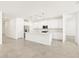 Modern kitchen boasts white cabinetry, stainless steel appliances, and a large center island with pendant lighting at 4032 S 176Th Dr, Goodyear, AZ 85338