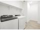 Bright laundry room featuring Whirlpool washer and dryer and ample shelving for organized storage at 4032 S 176Th Dr, Goodyear, AZ 85338
