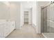 Modern bathroom featuring dual vanities, a glass-enclosed shower, and a tub for relaxation at 4032 S 176Th Dr, Goodyear, AZ 85338