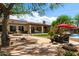 A large and landscaped backyard includes a water feature, covered patio, and a pool at 5744 E Hedgehog Pl, Scottsdale, AZ 85266