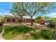A beautiful backyard with lush lawn, mature trees, swimming pool, and water feature at 5744 E Hedgehog Pl, Scottsdale, AZ 85266