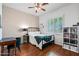 Bright bedroom with natural light, desk, and storage shelving, offering a comfortable space at 5744 E Hedgehog Pl, Scottsdale, AZ 85266