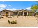 Charming desert landscaping adorns the front yard of this home with stucco exterior and covered porch at 5744 E Hedgehog Pl, Scottsdale, AZ 85266