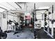 Bright garage gym equipped with an array of exercise equipment including a bike and weight rack at 5744 E Hedgehog Pl, Scottsdale, AZ 85266