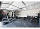 Spacious garage gym featuring workout machines, weights, and ample storage cabinets for the fitness enthusiast at 5744 E Hedgehog Pl, Scottsdale, AZ 85266