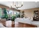 Bright living room with large windows offering lush backyard views and stylish decor at 5744 E Hedgehog Pl, Scottsdale, AZ 85266