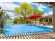 A sparkling pool with a waterfall feature surrounded by lush landscaping at 5744 E Hedgehog Pl, Scottsdale, AZ 85266