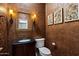 Elegant powder room featuring unique wall texture, stylish mirror, and modern fixtures at 5744 E Hedgehog Pl, Scottsdale, AZ 85266
