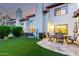 Backyard featuring lush green lawn, patio for outdoor dining, and stucco walls for privacy at 11011 N 92Nd St # 1010, Scottsdale, AZ 85260