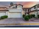 Charming home featuring a two-car garage, desert landscaping, and a Spanish tile roof at sunset at 11011 N 92Nd St # 1010, Scottsdale, AZ 85260