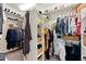 Bright walk-in closet featuring custom shelving, ample hanging space, and convenient storage for shoes and accessories at 12428 S 179Th Ln, Goodyear, AZ 85338