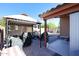 Inviting backyard featuring a gazebo with furniture, a BBQ, and a well-maintained patio at 14912 W Lamoille Dr, Surprise, AZ 85374