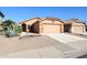 Charming single-story home with desert landscaping and attached two-car garage at 14912 W Lamoille Dr, Surprise, AZ 85374