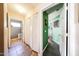 Hallway leading to the bedroom and laundry room with hardwood floors at 14912 W Lamoille Dr, Surprise, AZ 85374