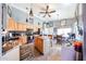 Charming kitchen featuring an island, wooden cabinets, and decorative lighting fixtures at 14912 W Lamoille Dr, Surprise, AZ 85374