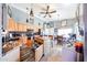 Charming kitchen featuring an island, wooden cabinets, and decorative lighting fixtures at 14912 W Lamoille Dr, Surprise, AZ 85374