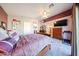 An angled view of the main bedroom with hard floors and purple accent walls at 14912 W Lamoille Dr, Surprise, AZ 85374