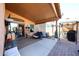 Spacious patio featuring a hot tub, covered seating, outdoor cooking area, and manicured landscaping at 14912 W Lamoille Dr, Surprise, AZ 85374