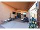 Cozy patio with an outdoor television, charming decorations, and comfortable seating for relaxation at 14912 W Lamoille Dr, Surprise, AZ 85374