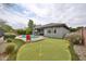 Backyard featuring a pool, putting green, and patio with comfortable seating at 16140 W Sierra St, Surprise, AZ 85379