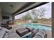 Outdoor space with pool, comfortable patio seating area, and lovely green landscaping at 16140 W Sierra St, Surprise, AZ 85379