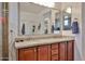 Bathroom featuring double sink vanity with granite countertop and brushed nickel hardware at 16140 W Sierra St, Surprise, AZ 85379