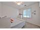 Bedroom featuring a single bed, dresser, window, and ceiling fan at 16140 W Sierra St, Surprise, AZ 85379