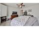 Bright bedroom with carpet, ceiling fan, dresser, and closet shelves at 16140 W Sierra St, Surprise, AZ 85379