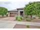 Charming single-story home with brick accents, a paver driveway, and well-maintained landscaping at 16140 W Sierra St, Surprise, AZ 85379