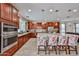 Well-equipped kitchen with stainless steel appliances, granite countertops, and island with barstools at 16140 W Sierra St, Surprise, AZ 85379