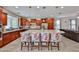 Open kitchen with dark wood cabinetry, granite countertops, and bar seating at the island at 16140 W Sierra St, Surprise, AZ 85379