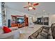Spacious living room featuring a ceiling fan, hardwood floors, and built-in entertainment center at 16140 W Sierra St, Surprise, AZ 85379