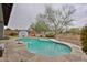 Backyard pool features stone patio, basketball hoop, and privacy wall in outdoor living space at 16140 W Sierra St, Surprise, AZ 85379