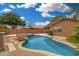 An inviting backyard pool is surrounded by desert landscaping and gravel at 1905 E Palomino Dr, Gilbert, AZ 85296