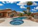 Private backyard oasis with a sparkling pool, spa, and tropical landscaping for ultimate relaxation at 1905 E Palomino Dr, Gilbert, AZ 85296