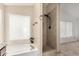 Bathroom featuring a soaking tub and a separate tiled shower with updated fixtures at 1905 E Palomino Dr, Gilbert, AZ 85296