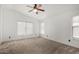 Spacious bedroom with a ceiling fan and plush carpeting, offering a comfortable retreat at 1905 E Palomino Dr, Gilbert, AZ 85296