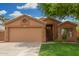 Cozy single-story home featuring a two-car garage and low-maintenance landscaping in a tidy front yard at 1905 E Palomino Dr, Gilbert, AZ 85296