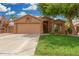 Inviting single-story home with a well-manicured lawn and a spacious driveway leading to the garage at 1905 E Palomino Dr, Gilbert, AZ 85296
