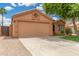 Well-maintained single-story home with a two-car garage, concrete driveway, and low water use landscaping at 1905 E Palomino Dr, Gilbert, AZ 85296