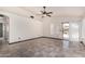 Bright living room with vaulted ceiling, neutral walls, and tile flooring leading to outdoor pool area at 1905 E Palomino Dr, Gilbert, AZ 85296