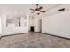 Spacious living area featuring tile flooring, neutral walls, and an open layout at 1905 E Palomino Dr, Gilbert, AZ 85296