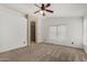 Large bedroom features neutral carpet, ceiling fan, and ensuite bathroom at 1905 E Palomino Dr, Gilbert, AZ 85296