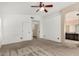Neutral main bedroom features ceiling fan, archway and ensuite bathroom at 1905 E Palomino Dr, Gilbert, AZ 85296